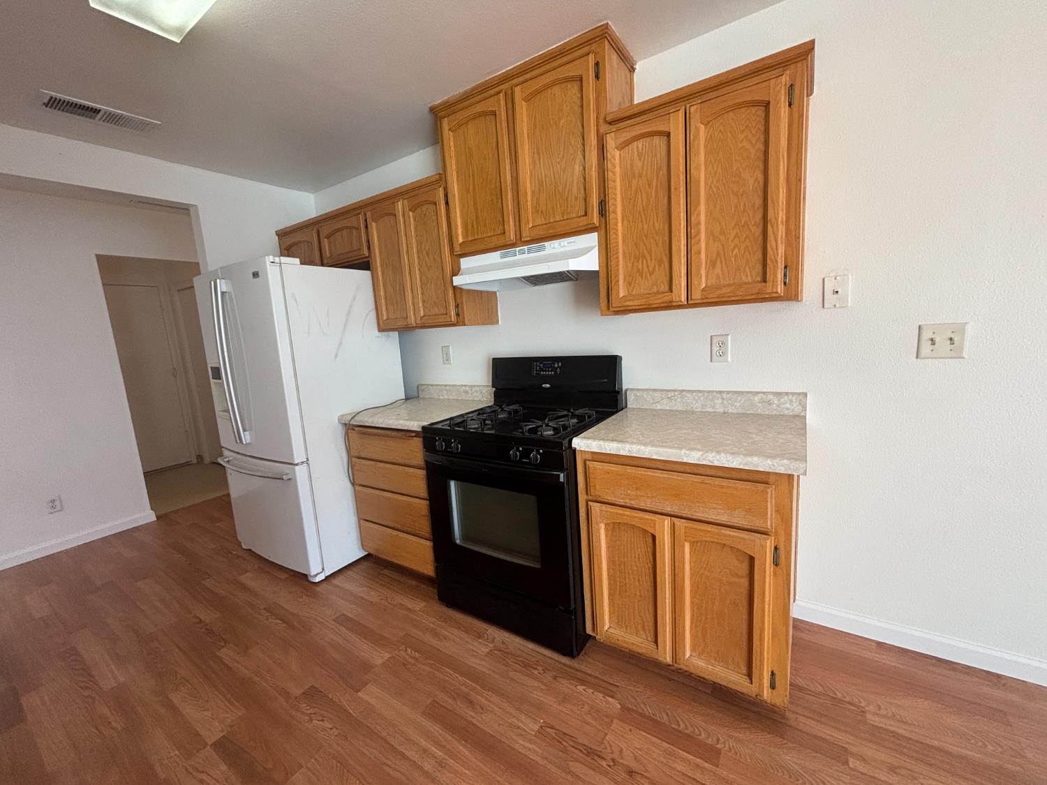 813 Morton Avenue Sanger, CA 93657 - Photo 6 of 19 a kitchen with a refrigerator sink and stove