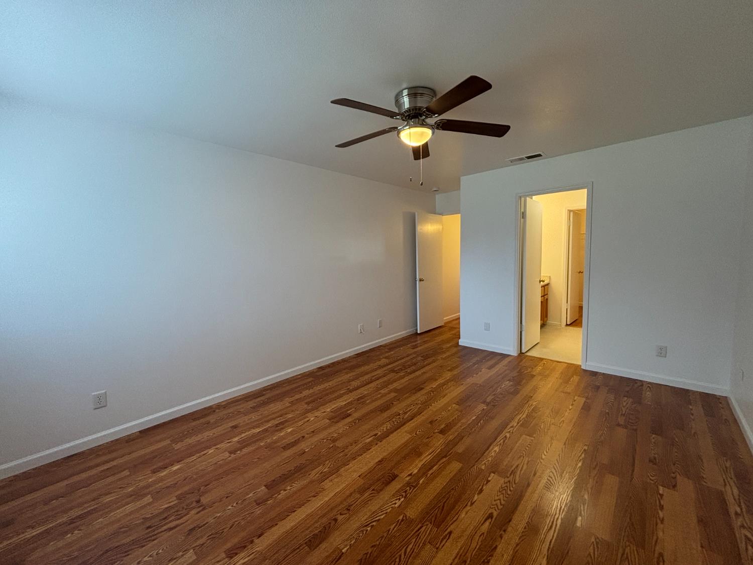 813 Morton Avenue Sanger, CA 93657 - Photo 9 of 19 a view of an empty room with window and wooden floor