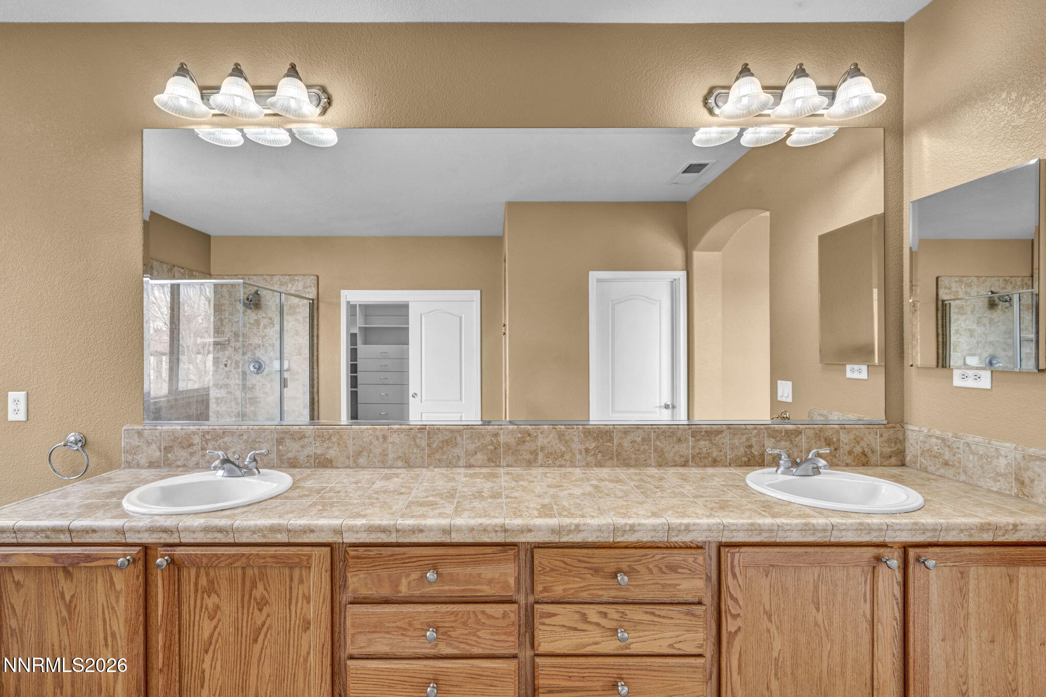 475 Parade Drive Reno, NV 89521 - Photo 102 of 113 a bathroom with a granite countertop sink a large mirror and a chandelier