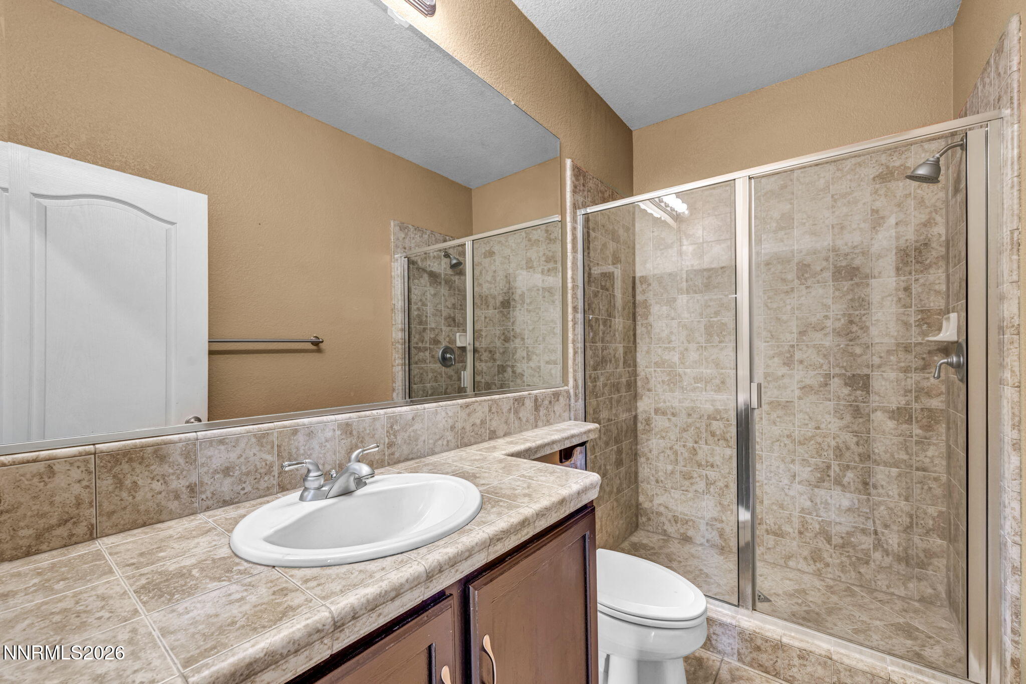 475 Parade Drive Reno, NV 89521 - Photo 110 of 113 a bathroom with a granite countertop sink a toilet and shower
