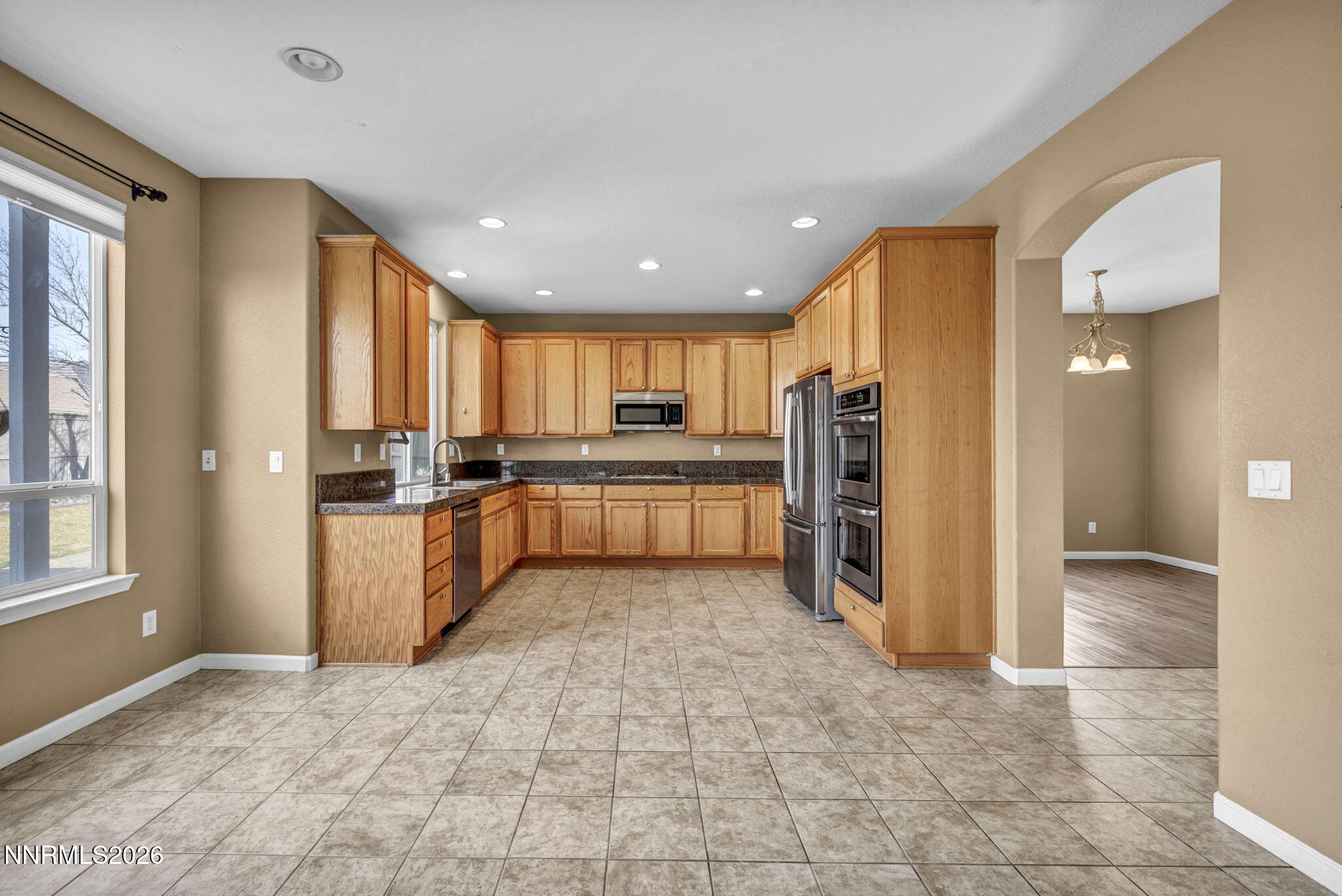 475 Parade Drive Reno, NV 89521 - Photo 18 of 113 a large kitchen with a refrigerator and a counter top space