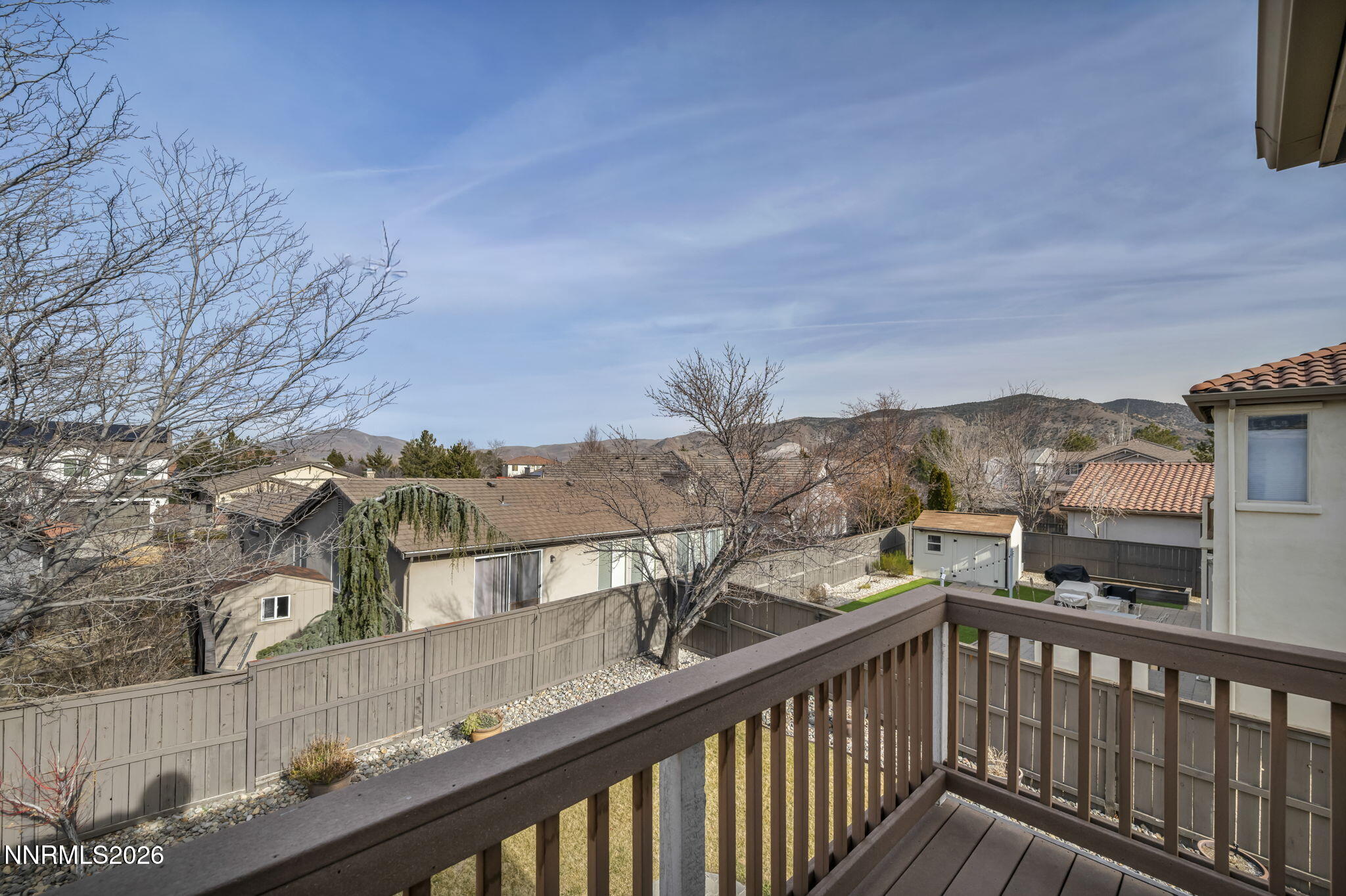 475 Parade Drive Reno, NV 89521 - Photo 50 of 113 a view of a balcony with wooden fence and floor