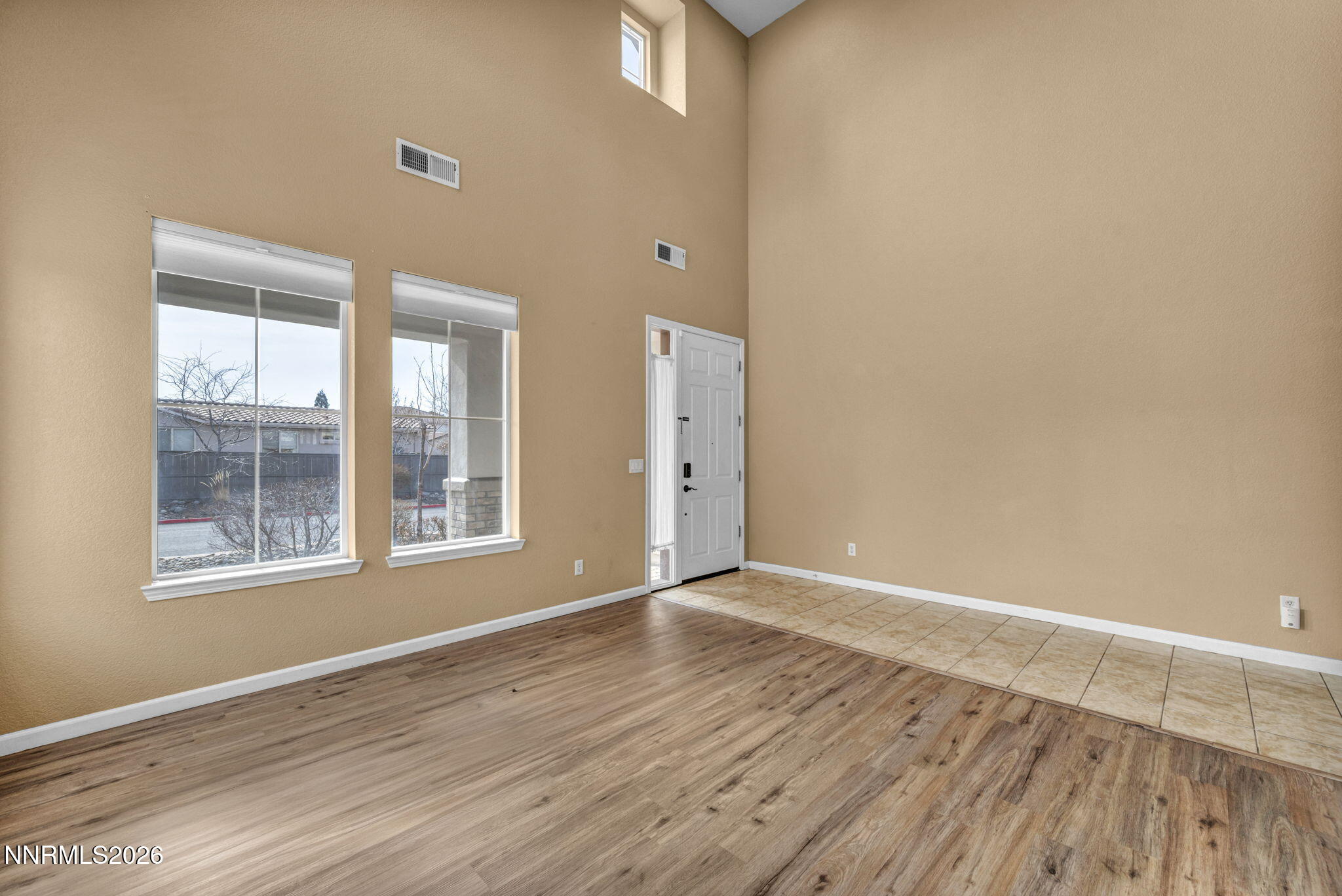 475 Parade Drive Reno, NV 89521 - Photo 54 of 113 an empty room with wooden floor and windows