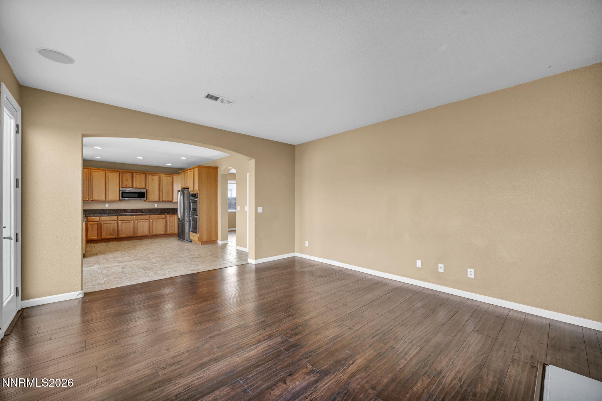 475 Parade Drive Reno, NV 89521 - Photo 72 of 113 a view of an empty room with window and wooden floor