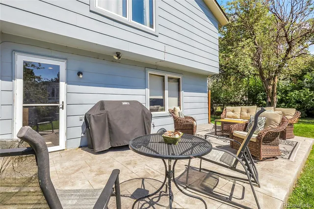 a view of a patio with table and chairs and potted plants