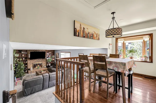 a dining room with furniture window and wooden floor