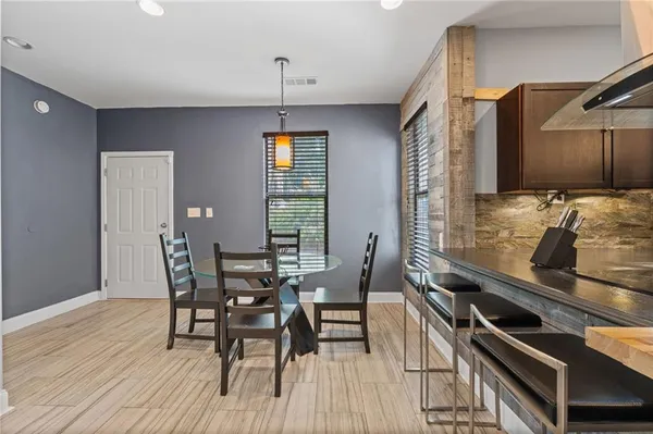 a kitchen with a stove and a wooden floor