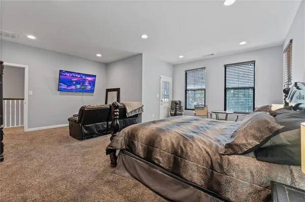 a bed sitting in a bedroom next to a window