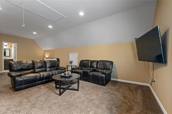a living room with furniture and kitchen view