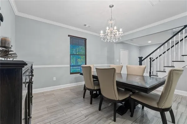 a kitchen with stainless steel appliances kitchen island granite countertop a stove a sink and a refrigerator