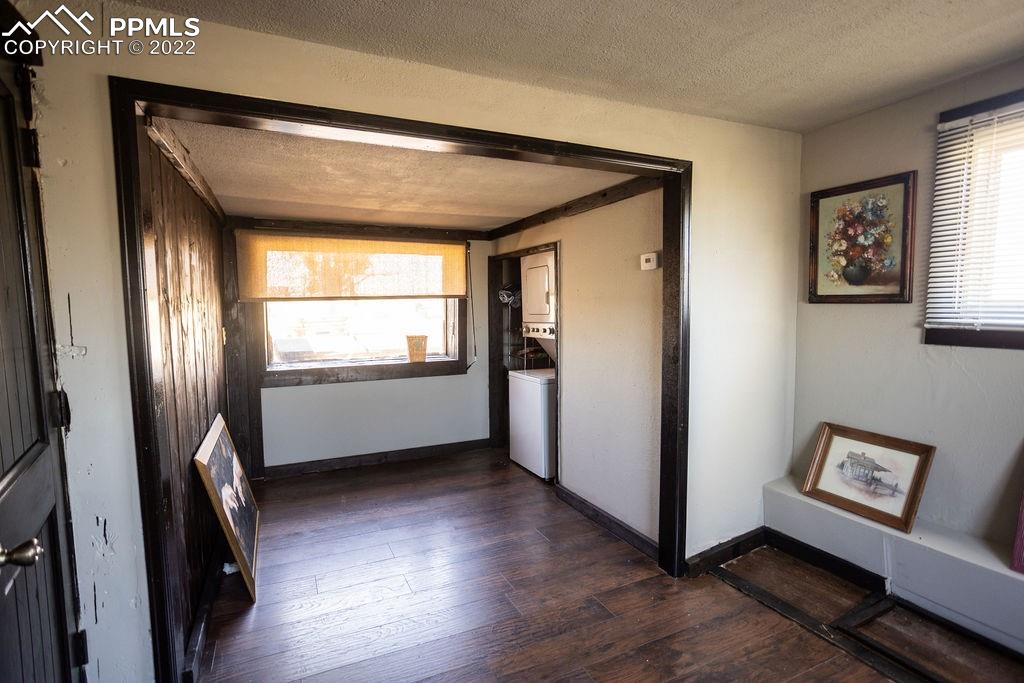 30915 Washington Road Calhan, CO 80808 - Photo 11 of 29 a view of an empty room with wooden floor and a window