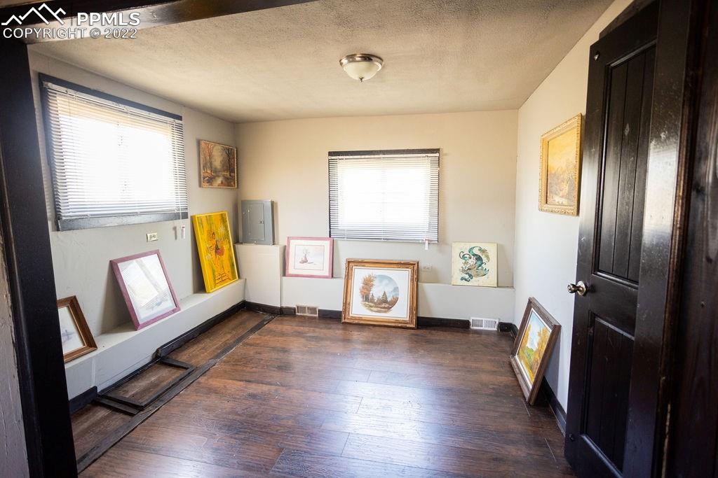 30915 Washington Road Calhan, CO 80808 - Photo 12 of 29 a view of an empty room with window and wooden floor