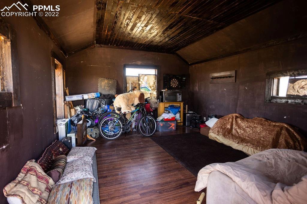 30915 Washington Road Calhan, CO 80808 - Photo 17 of 29 a bedroom with furniture and a wooden floor
