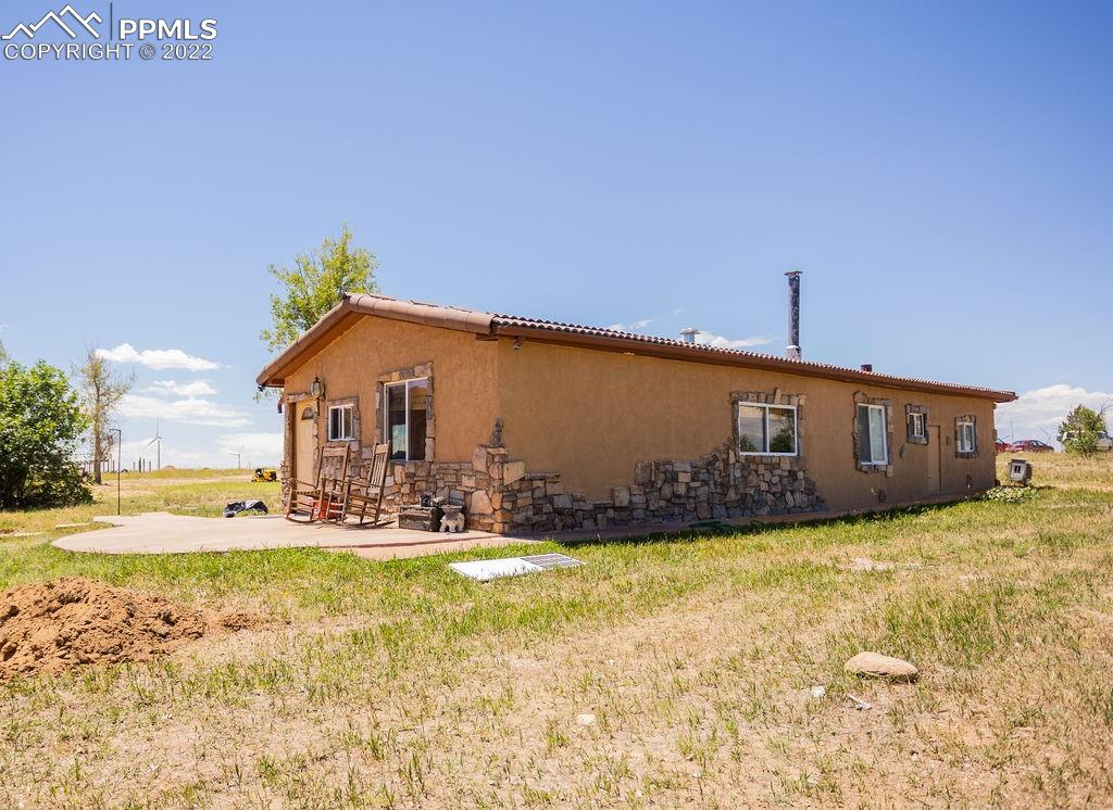 30915 Washington Road Calhan, CO 80808 - Photo 18 of 29 a view of a house with backyard and sitting area