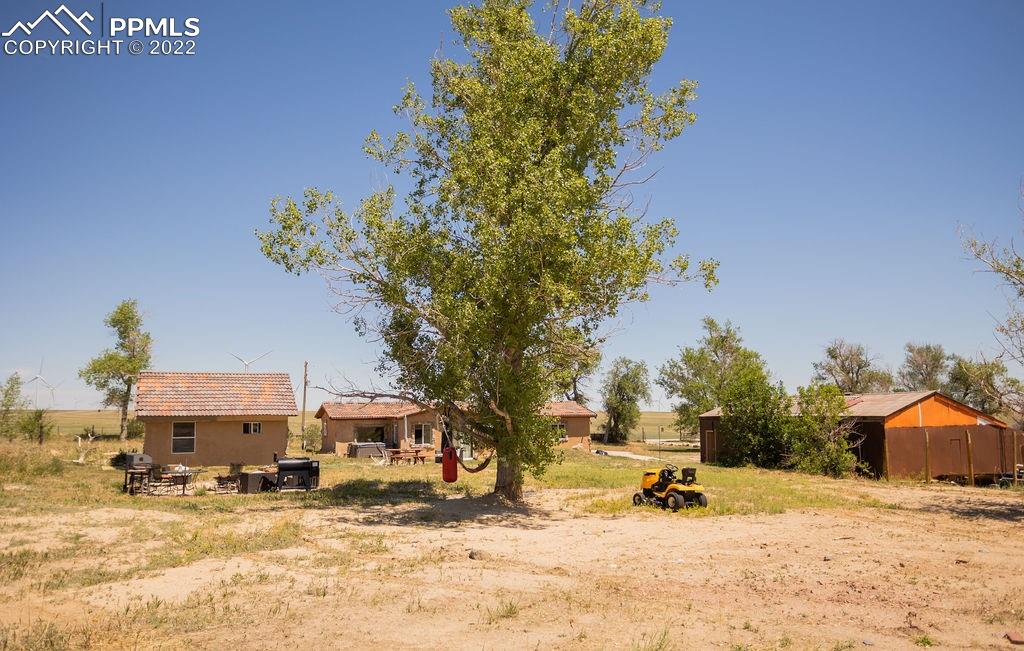 30915 Washington Road Calhan, CO 80808 - Photo 23 of 29 a wooden bench sitting in front of a house