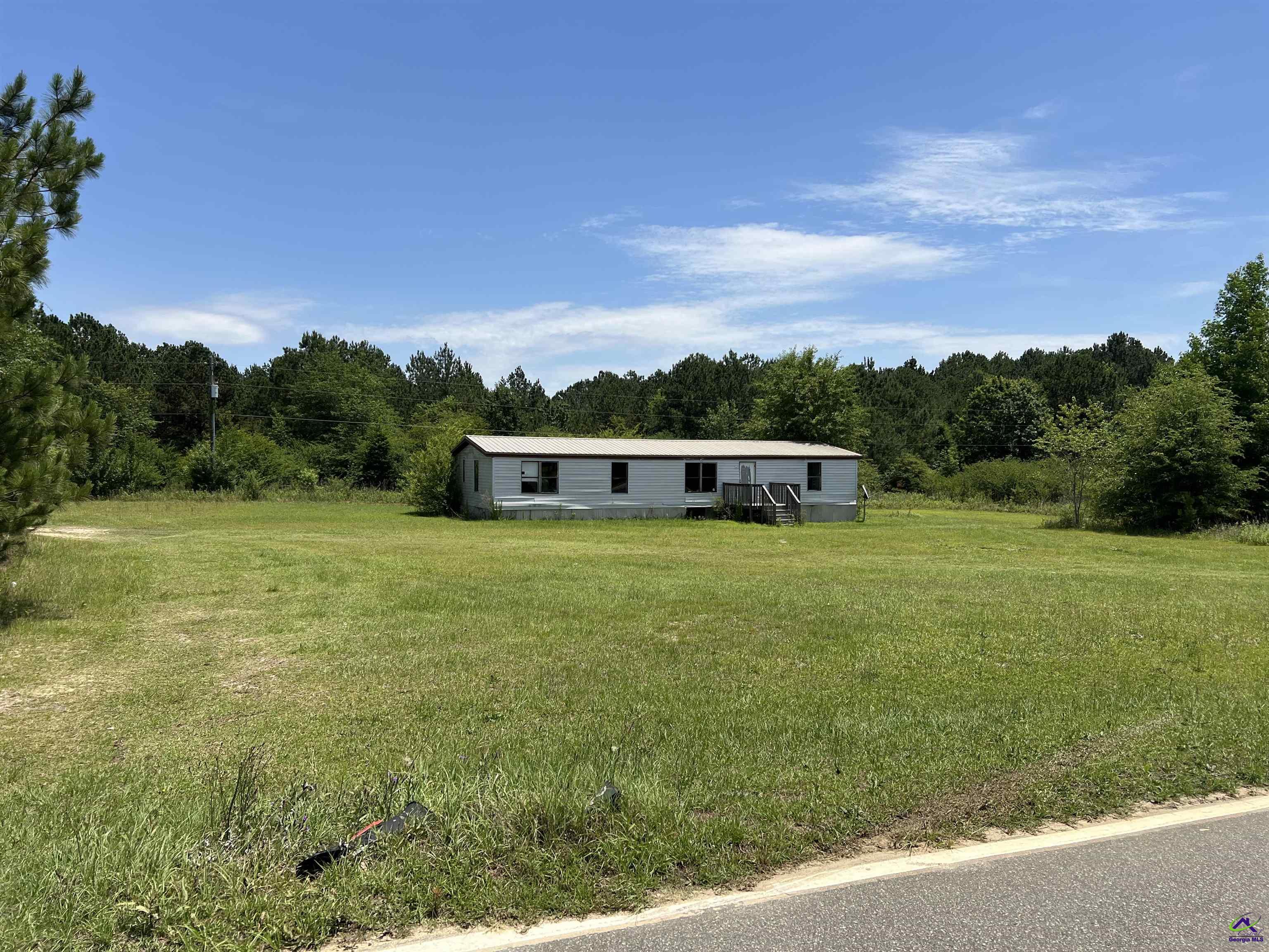 Rock Hill Road Cochran, GA 31014 - Photo 23 of 26 a front view of a house with a garden