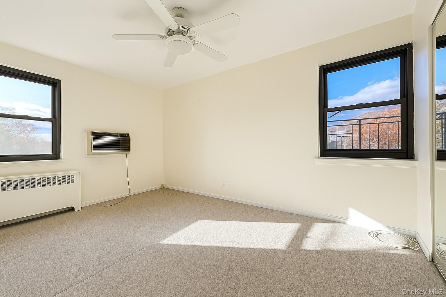 7 Terrace, Unit 3H Great Neck, NY 11021 - Photo 13 of 37 an empty room with windows and cabinet
