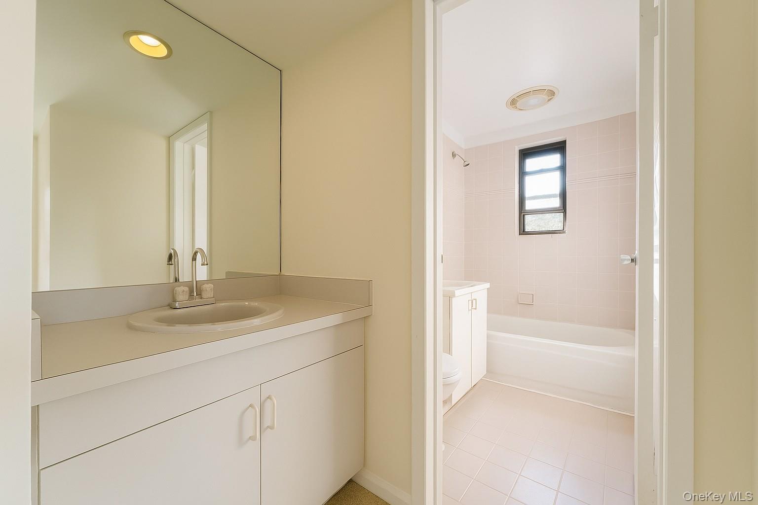 7 Terrace, Unit 3H Great Neck, NY 11021 - Photo 15 of 37 a bathroom with a sink a toilet and shower