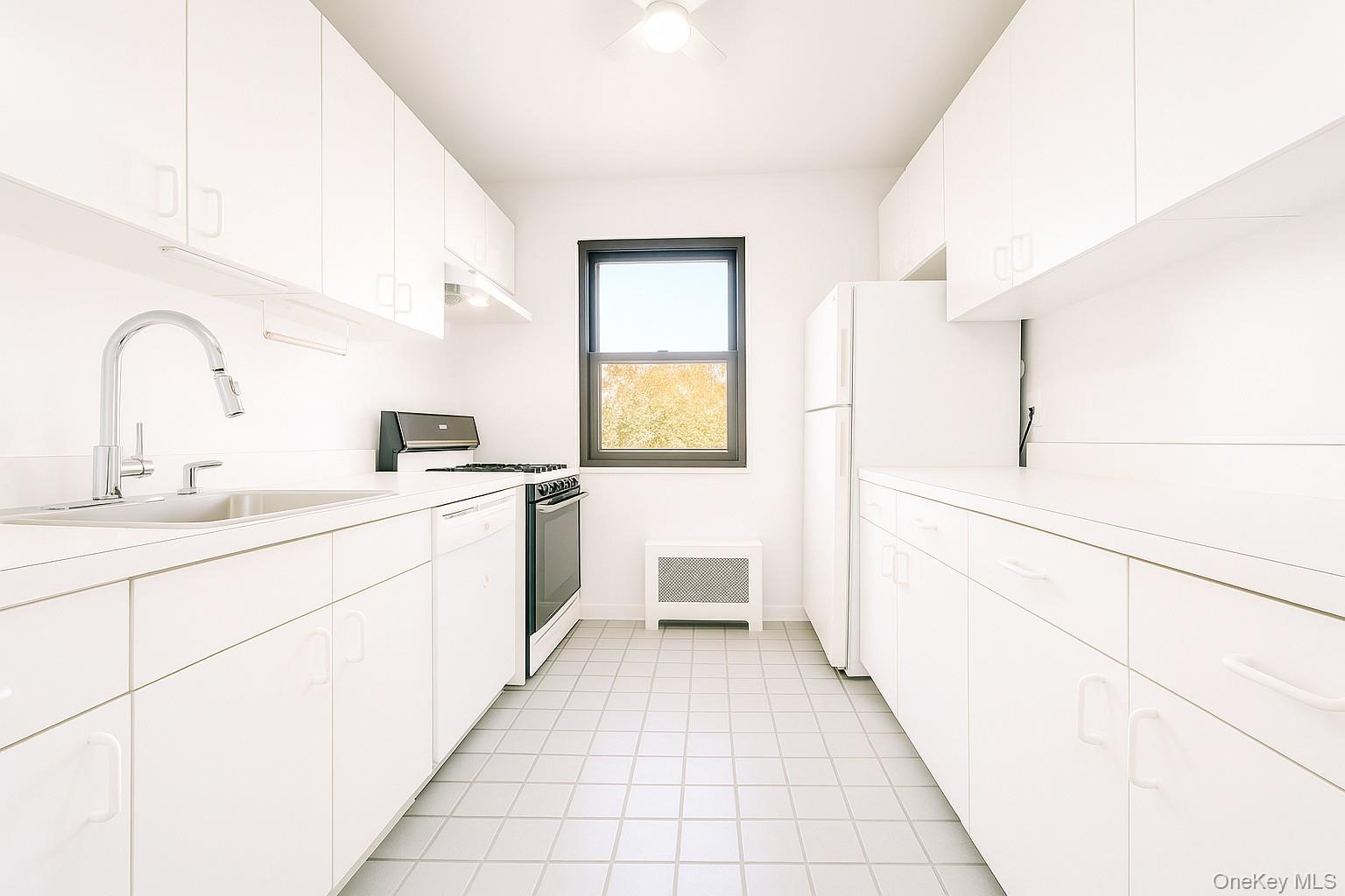 7 Terrace, Unit 3H Great Neck, NY 11021 - Photo 17 of 37 a large white room with a sink and cabinets