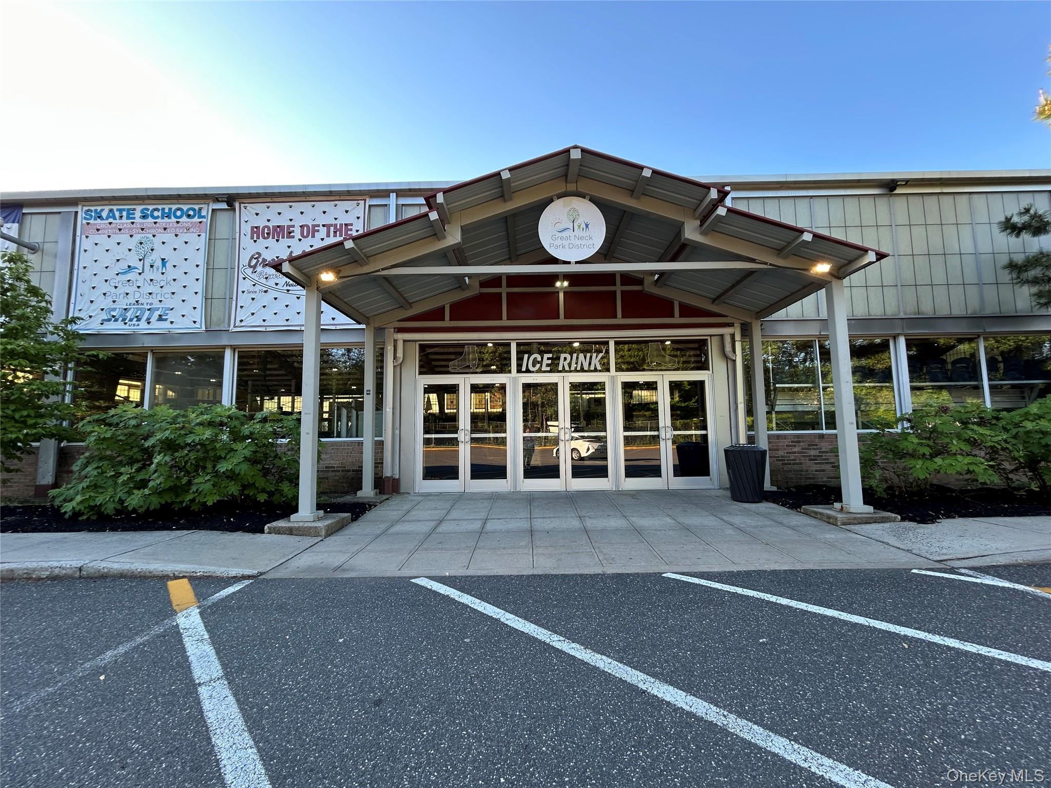 7 Terrace, Unit 3H Great Neck, NY 11021 - Photo 35 of 37 a front view of a building with a yard and potted plants