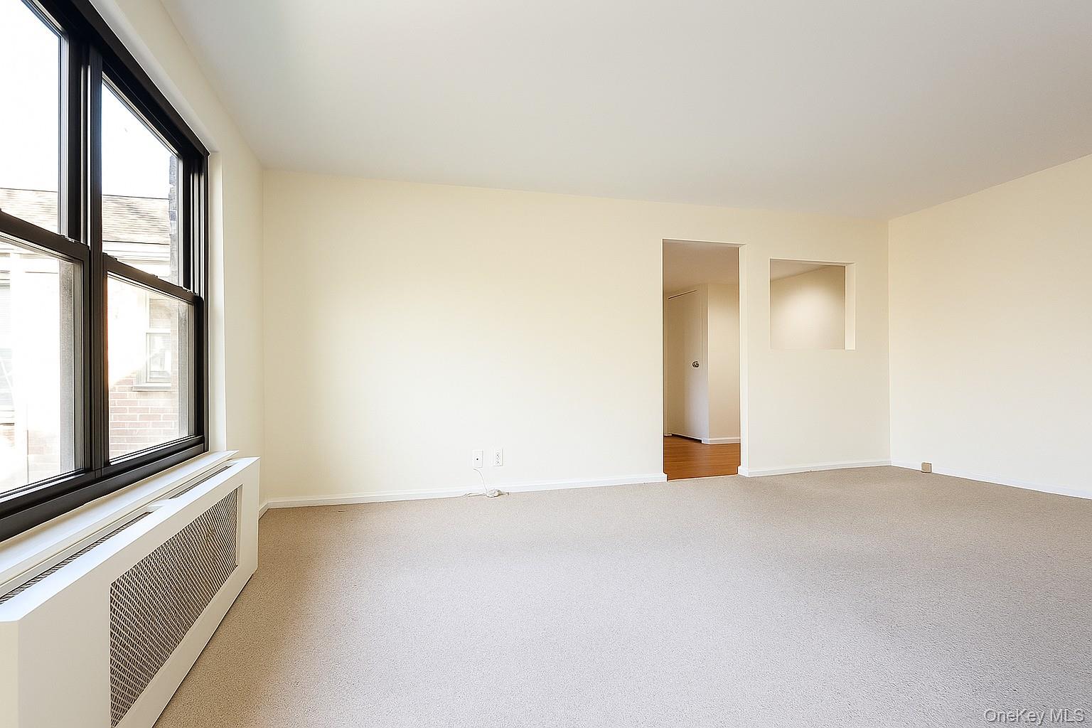 7 Terrace, Unit 3H Great Neck, NY 11021 - Photo 4 of 37 a view of an empty room with a window