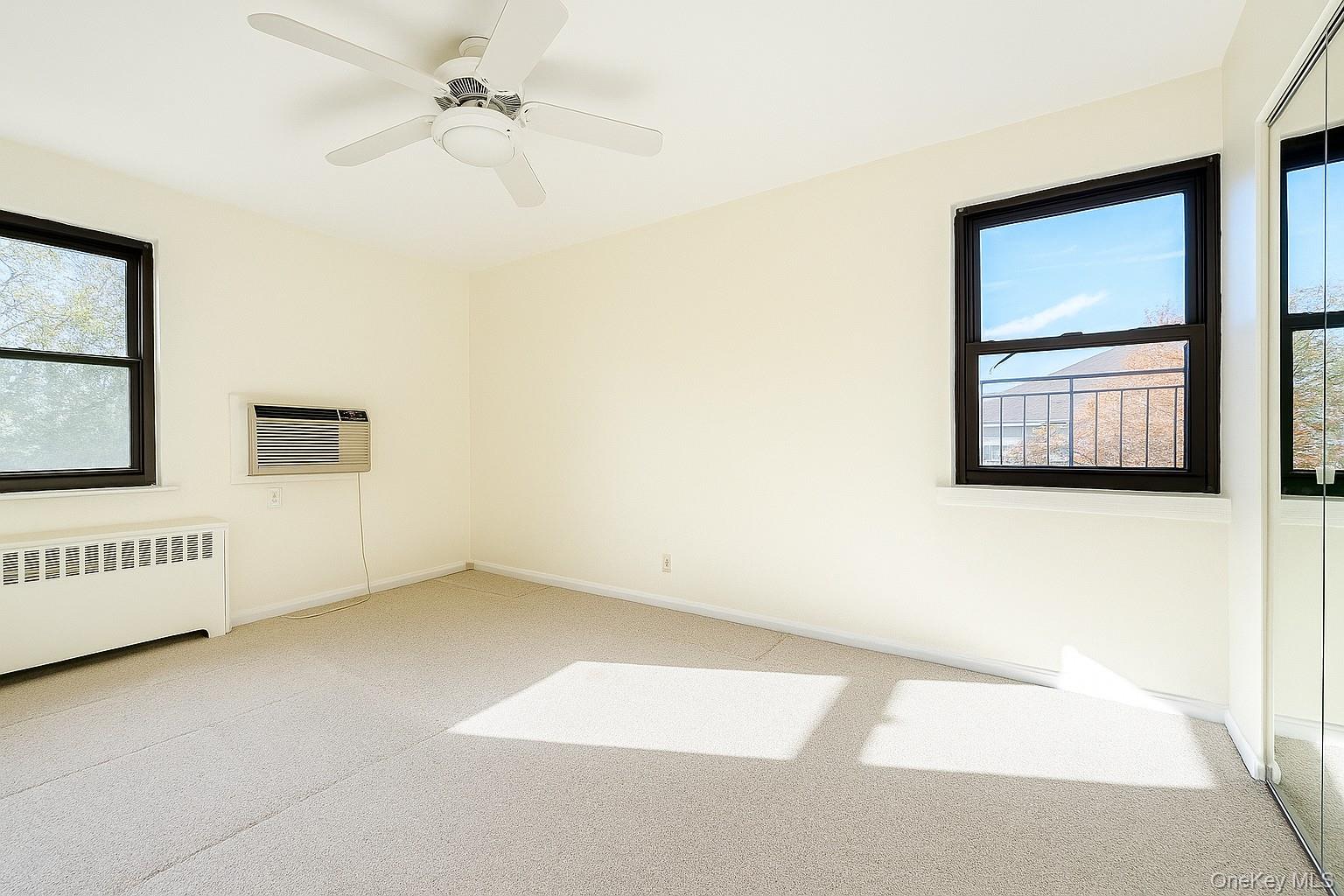 7 Terrace, Unit 3H Great Neck, NY 11021 - Photo 9 of 37 an empty room with windows and cabinet