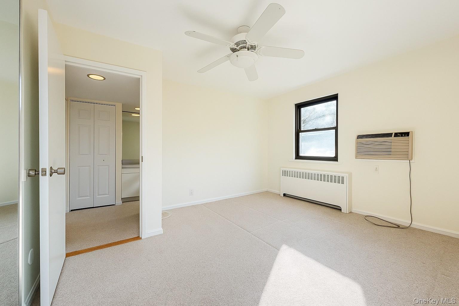 7 Terrace, Unit 3H Great Neck, NY 11021 - Photo 10 of 37 an empty room with windows and closet