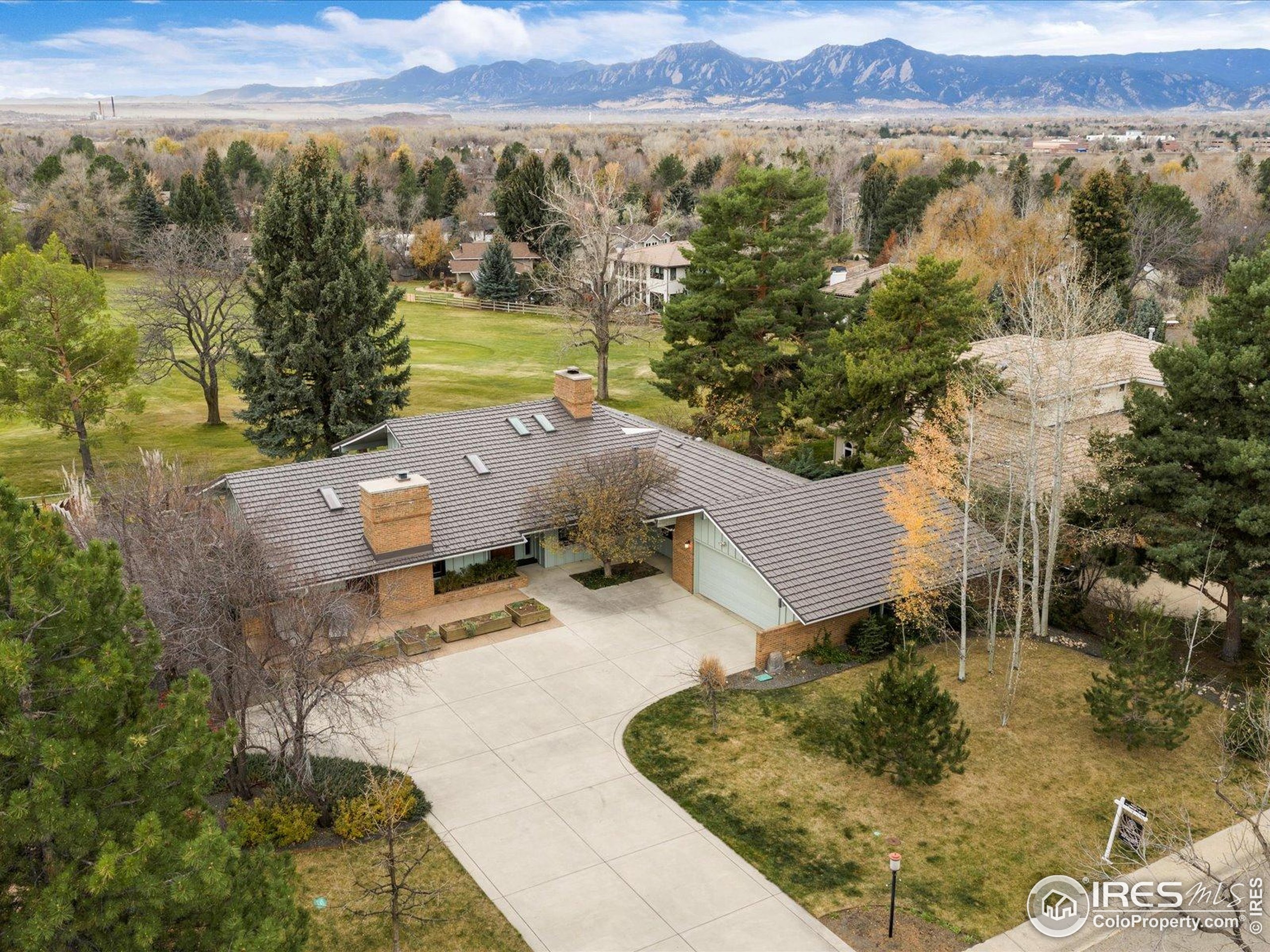 6972 Roaring Fork Trail Boulder, CO 80301 - Photo 3 of 35 a view of a house with a yard and mountain view