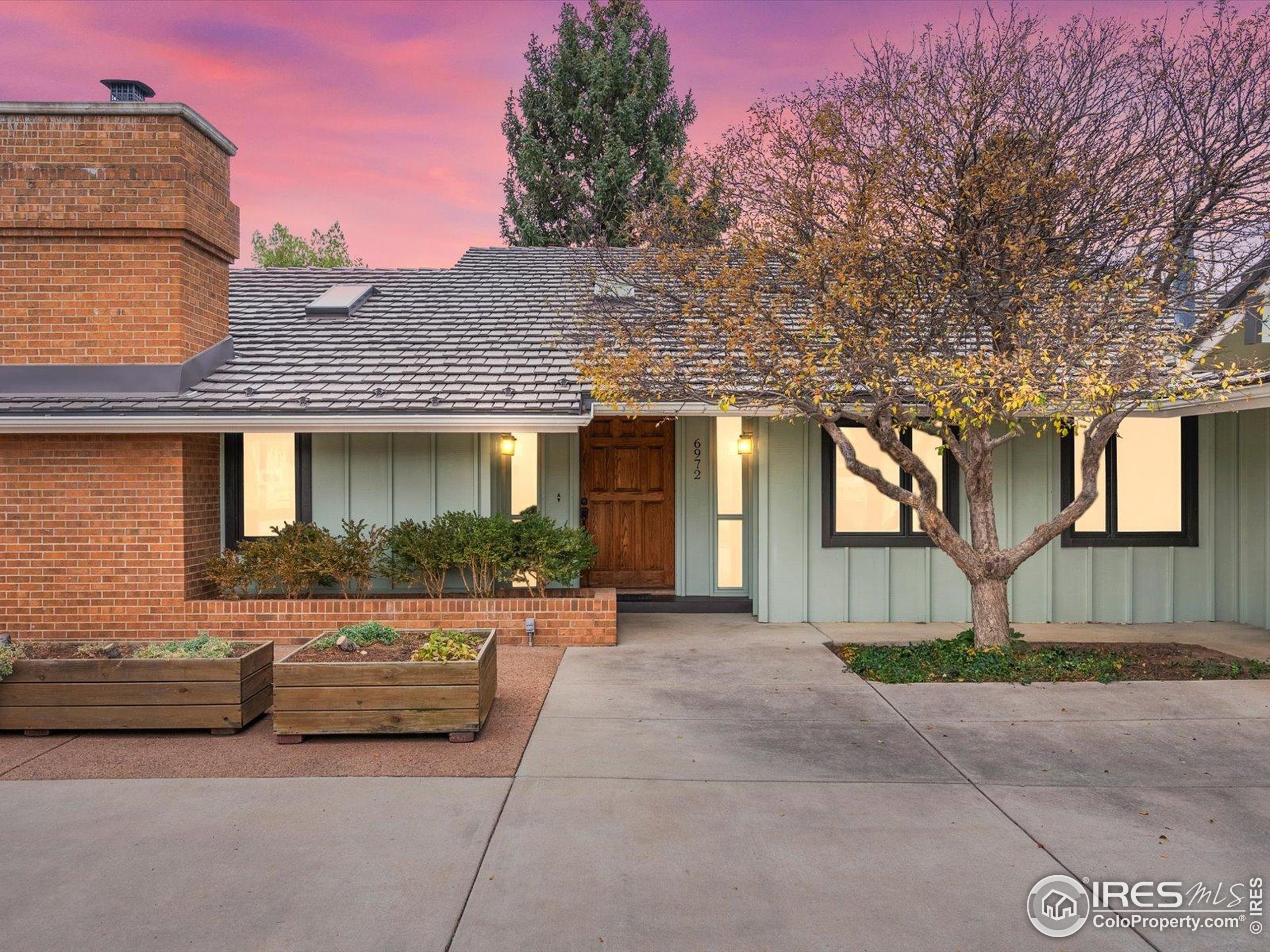 6972 Roaring Fork Trail Boulder, CO 80301 - Photo 4 of 35 a front view of a house with a yard and garage