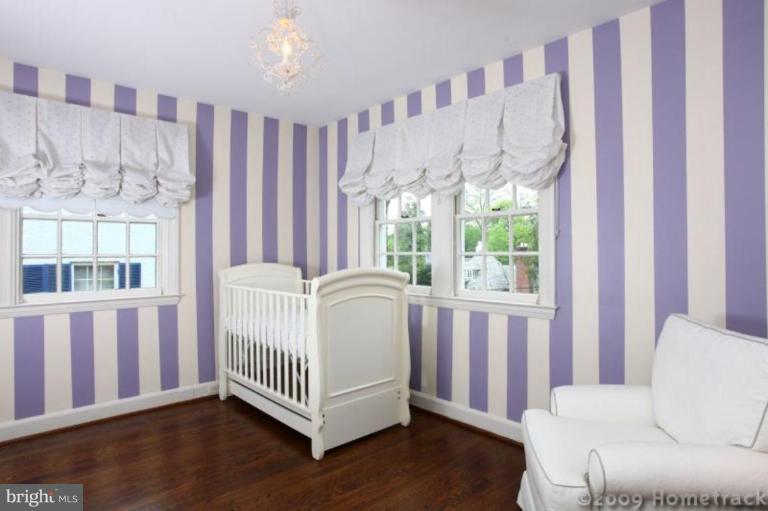 213 Tunbridge Road Baltimore, MD 21212 - Photo 11 of 24 a view of a bedroom with wooden floor and windows