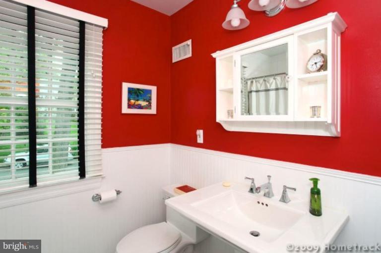 213 Tunbridge Road Baltimore, MD 21212 - Photo 21 of 24 a bathroom with a sink and a mirror