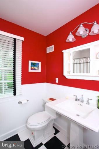 213 Tunbridge Road Baltimore, MD 21212 - Photo 22 of 24 a bathroom with a sink a toilet and a mirror