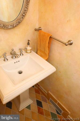 213 Tunbridge Road Baltimore, MD 21212 - Photo 24 of 24 a bathroom with a sink and a mirror