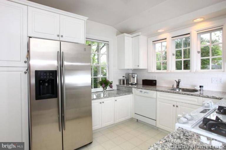 213 Tunbridge Road Baltimore, MD 21212 - Photo 5 of 24 a kitchen with a refrigerator sink and cabinets