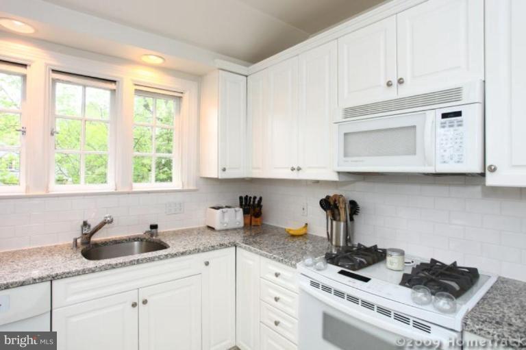 213 Tunbridge Road Baltimore, MD 21212 - Photo 6 of 24 a kitchen with granite countertop white cabinets and white appliances