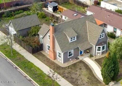 an aerial view of a house with a yard