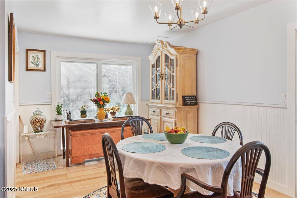335 South F Street Lompoc, CA 93436 - Photo 11 of 44 a dining room with furniture a chandelier and window