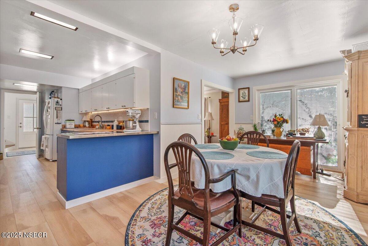 335 South F Street Lompoc, CA 93436 - Photo 13 of 44 a view of a a dining room with furniture window and wooden floor