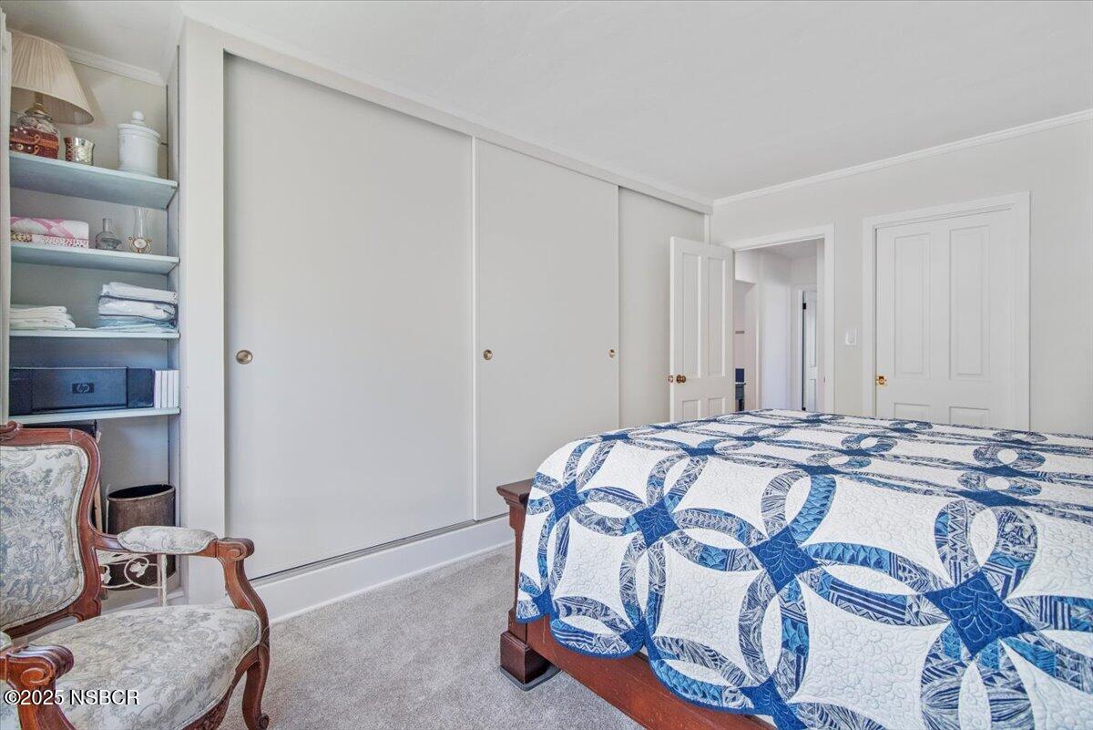 335 South F Street Lompoc, CA 93436 - Photo 20 of 44 a bed sitting in a bedroom and table room