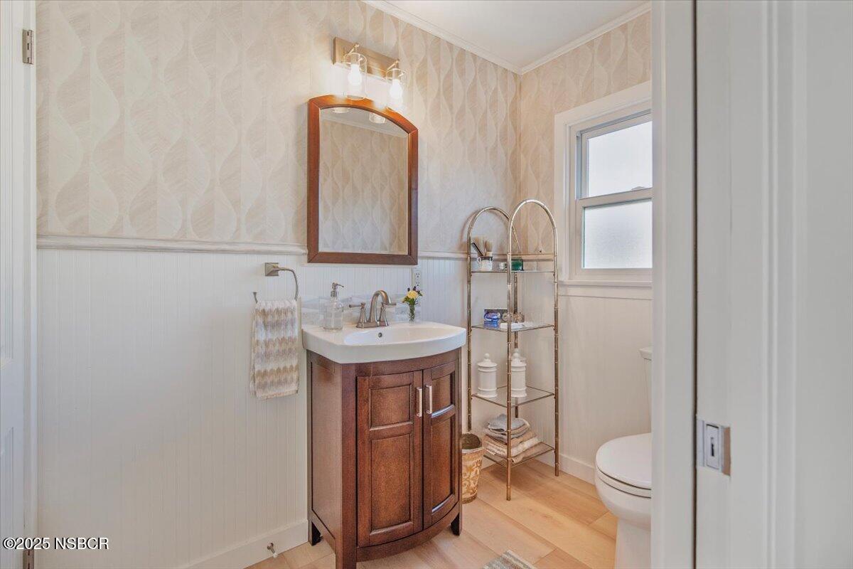 335 South F Street Lompoc, CA 93436 - Photo 22 of 44 a bathroom with a sink toilet and a mirror
