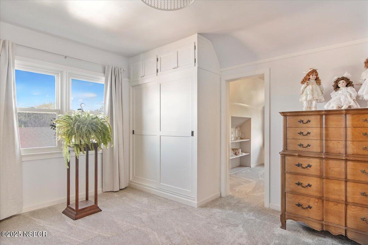 335 South F Street Lompoc, CA 93436 - Photo 25 of 44 a view of a bedroom with a dresser and mirror