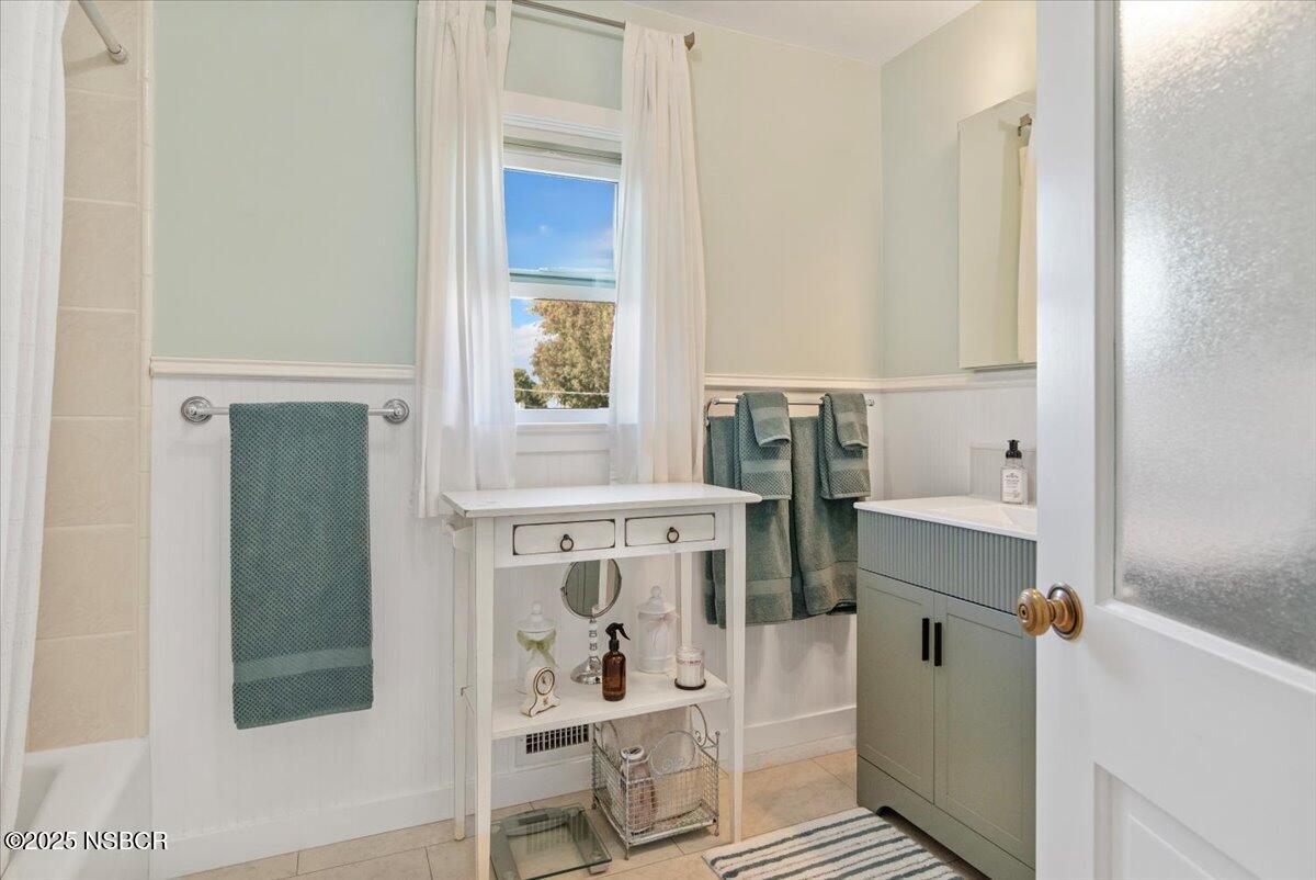 335 South F Street Lompoc, CA 93436 - Photo 28 of 44 a bathroom with a bathtub and shower