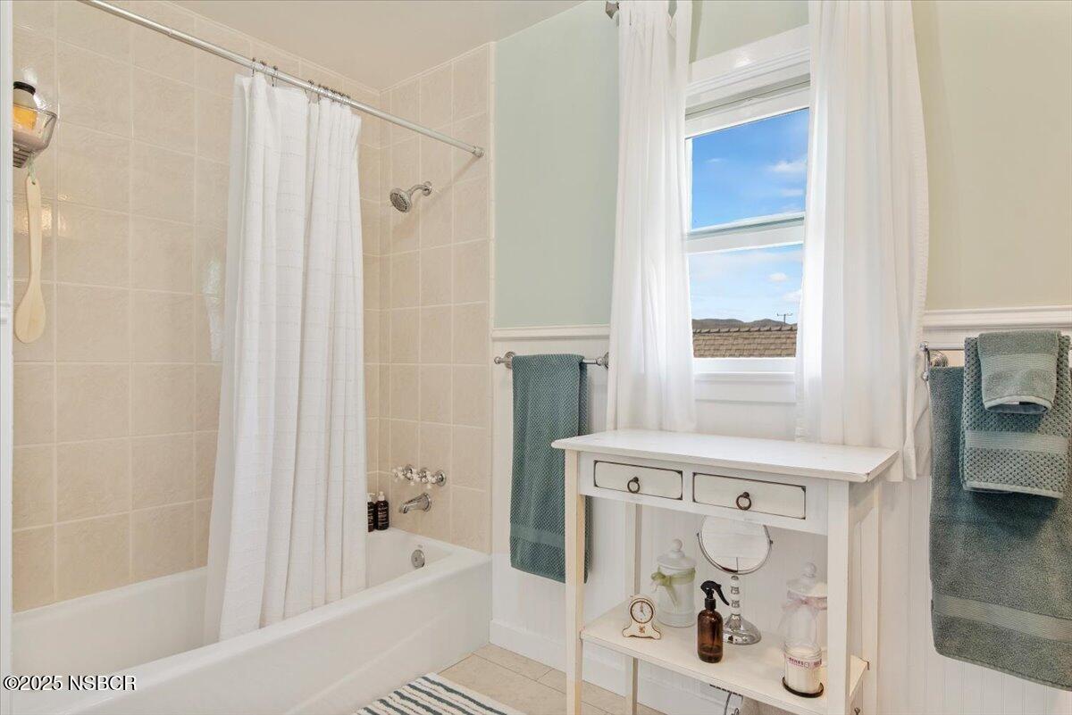 335 South F Street Lompoc, CA 93436 - Photo 29 of 44 a bathroom with a bathtub and a shower