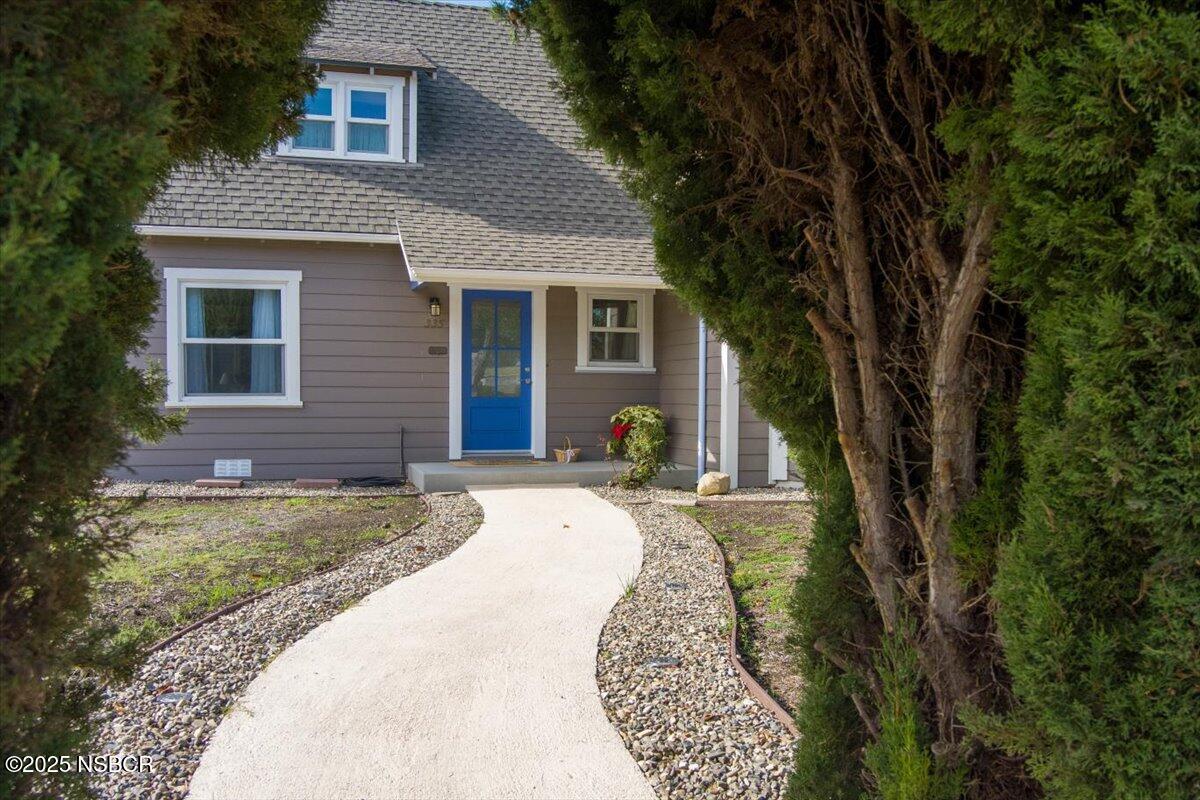 335 South F Street Lompoc, CA 93436 - Photo 3 of 44 a front view of a house with a yard
