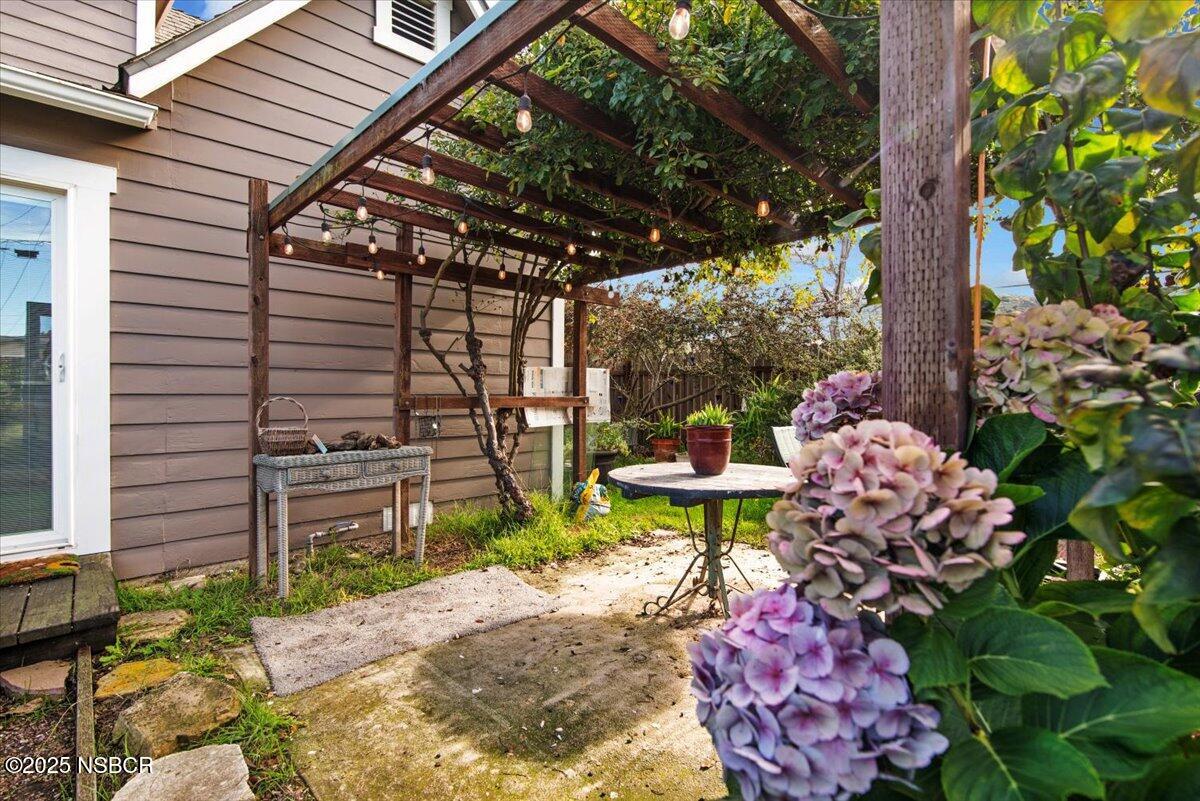 335 South F Street Lompoc, CA 93436 - Photo 34 of 44 a chair and table in a backyard