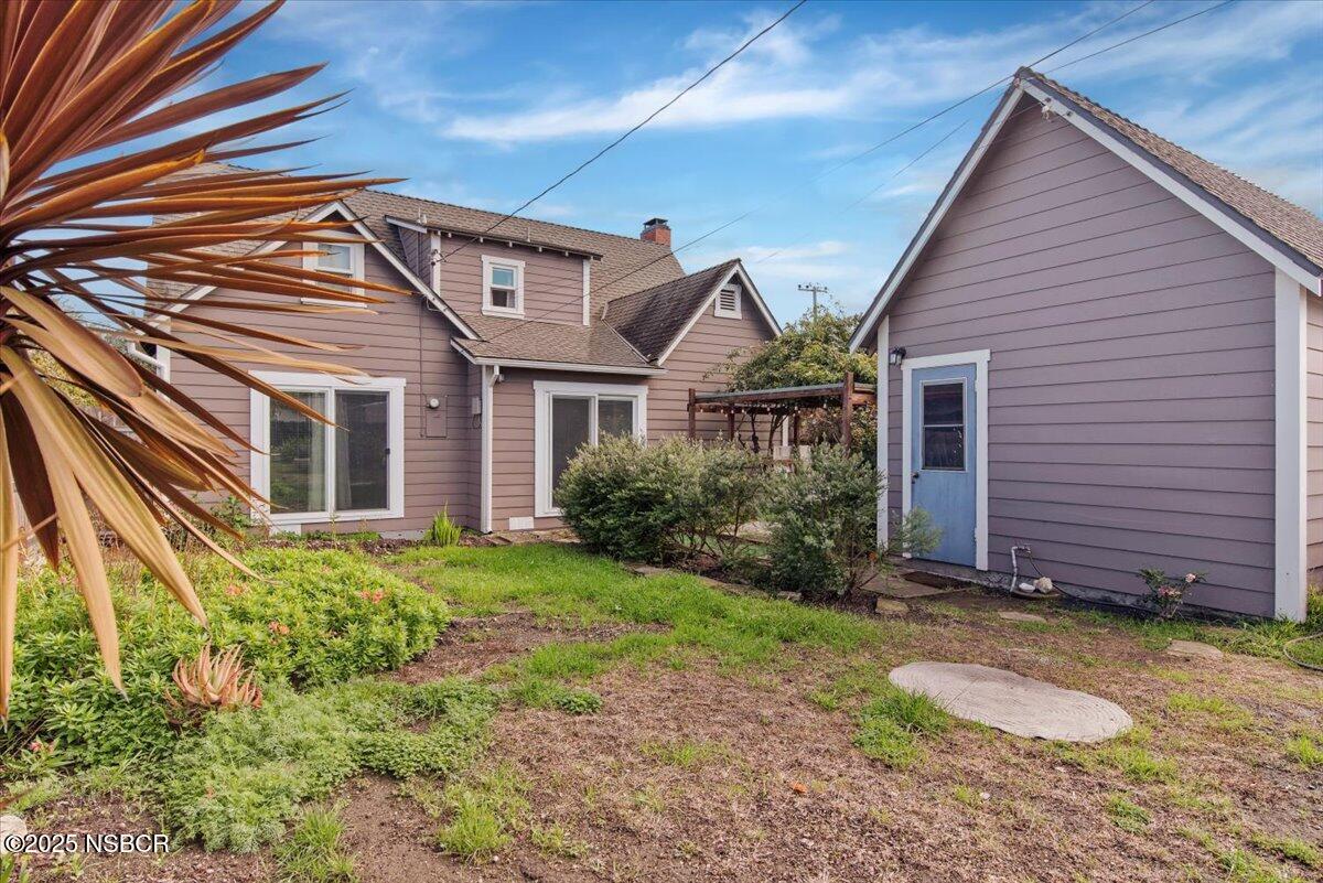 335 South F Street Lompoc, CA 93436 - Photo 37 of 44 a view of a house with brick walls and a yard with plants