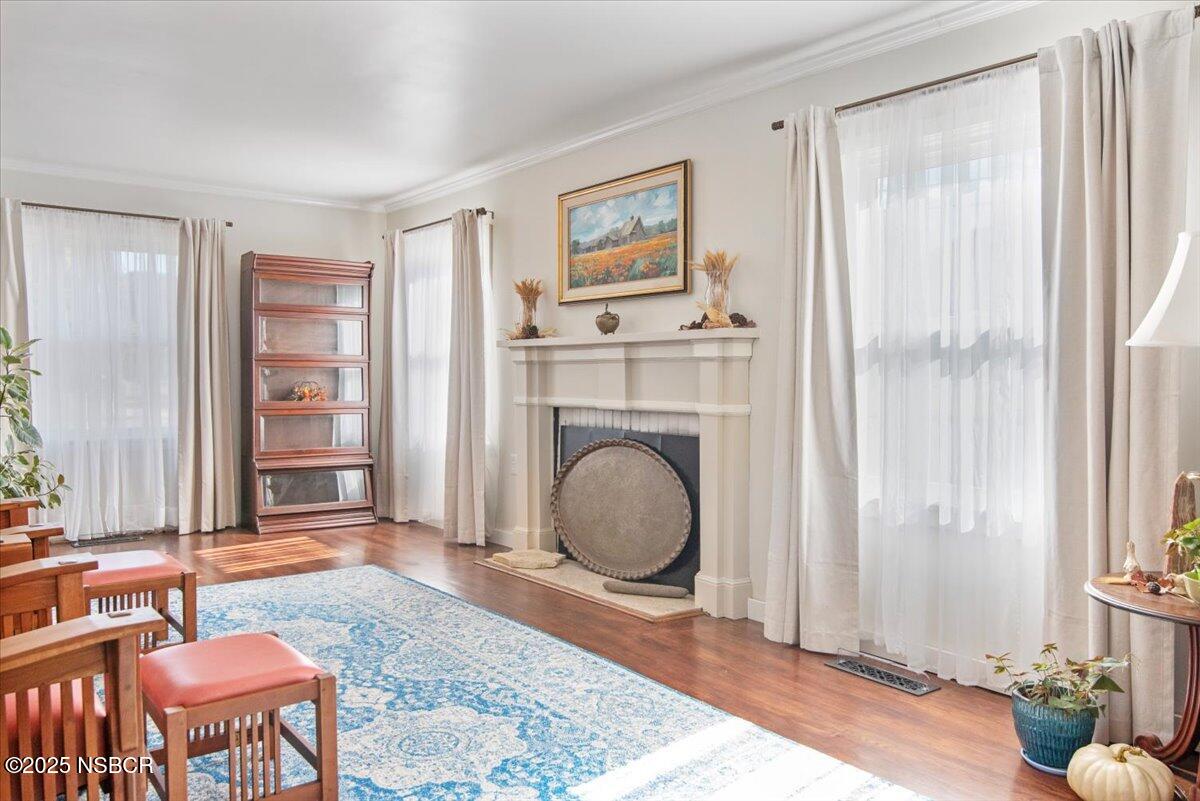 335 South F Street Lompoc, CA 93436 - Photo 8 of 44 a living room with furniture a window and a fireplace