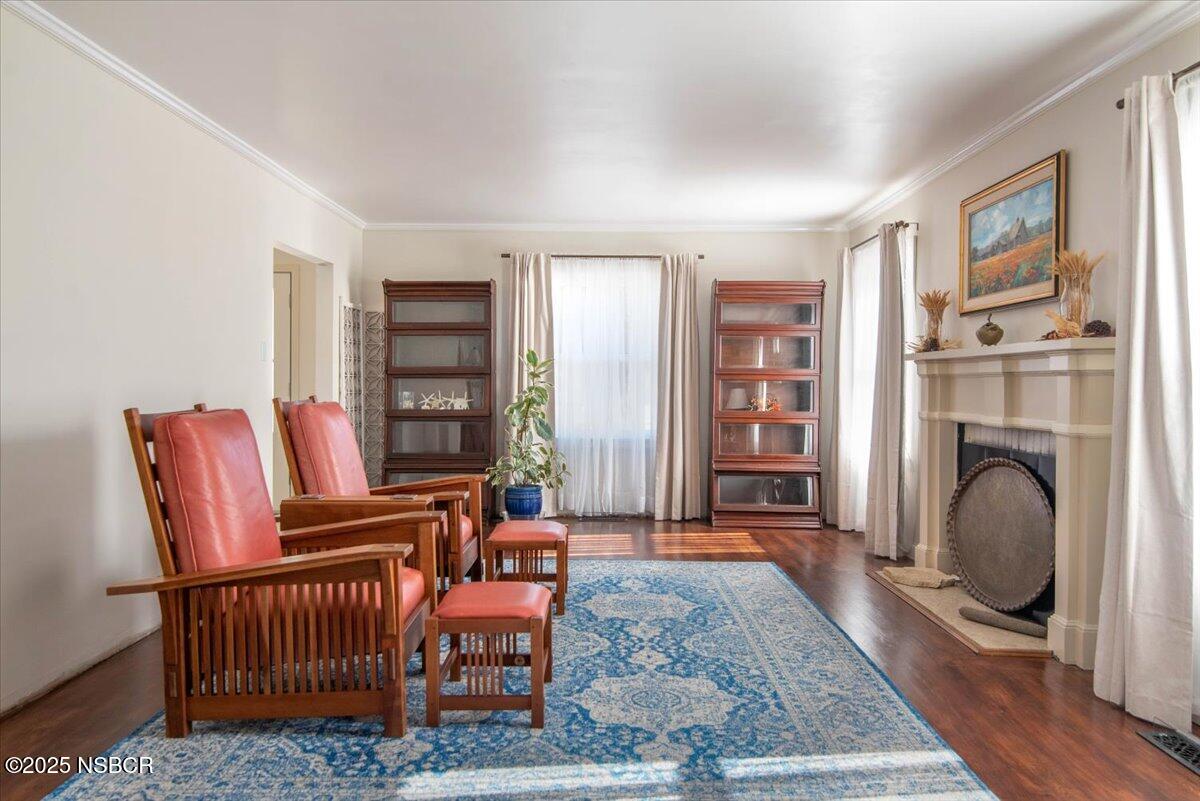 335 South F Street Lompoc, CA 93436 - Photo 9 of 44 a living room with furniture a rug and a fireplace