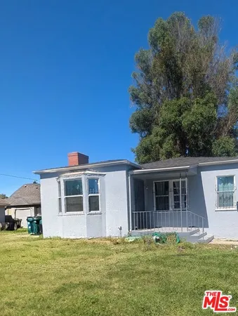 a big house with a big yard and large trees