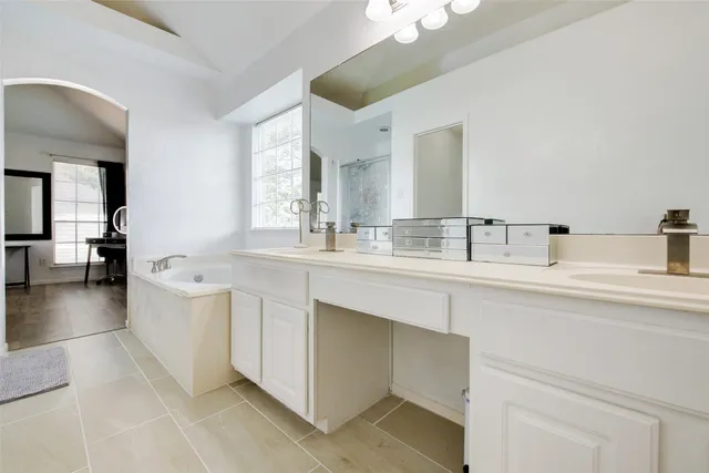 a bathroom with a sink a large mirror and vanity
